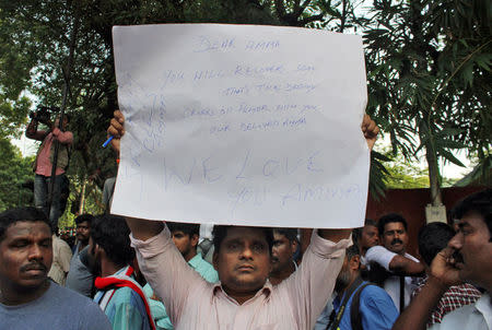 A well wisher of Tamil Nadu Chief Minister Jayalalithaa Jayaraman holds a placard with a recovery message outside a hospital where Jayalalithaa is being treated in Chennai, India, December 5, 2016. REUTERS/Stringer FOR EDITORIAL USE ONLY. NO RESALES. NO ARCHIVES.