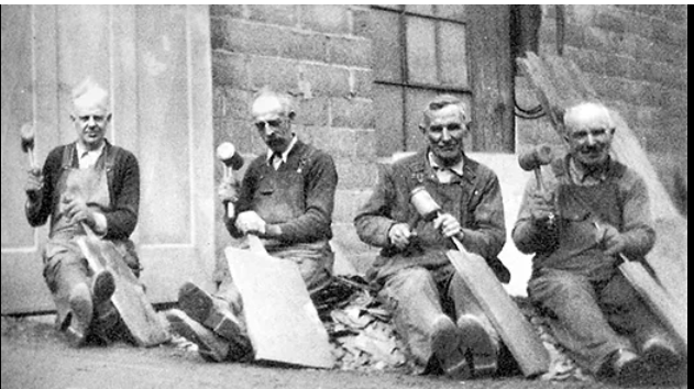 These craftsmen, Welsh quarrymen from the Funkhouser Quarry near Delta, demonstrate the practice of slate splitting about 1930.