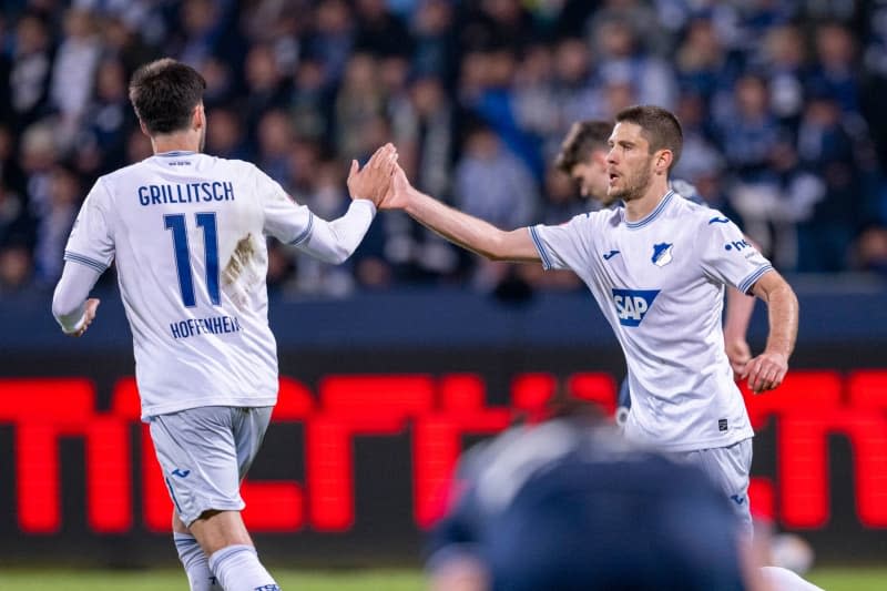 Hoffenheim's Andrej Kramaric (R) celebrates scoring his side's first goal with teammate Florian Grillitsch during the German Bundesliga soccer match between VfL Bochum and TSG 1899 Hoffenheim at the Vonovia Ruhrstadion. David Inderlied/dpa