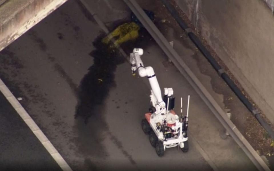 Bomb disposal robot examining a suspicious object found under a bridge on the M1  - PA