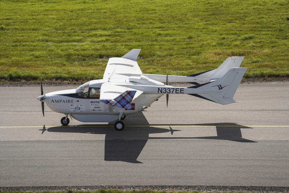 NEWQUAY, ENGLAND - AUGUST 24: A demonstration flight by the Ampaire hybrid-powered Cessna 337 Skymaster electric aircraft lands at Newquay Airport on August 24, 2021 in Newquay, England. The modified six-seat plane features a battery-powered motor at the front and conventional combusiton engines at the rear, enabling a reduction in emissions and operating costs by as much as 30%. The flights are part of a series of government-backed trails aimed at moving the UK towards green aviation.  (Photo by Hugh Hastings/Getty Images)