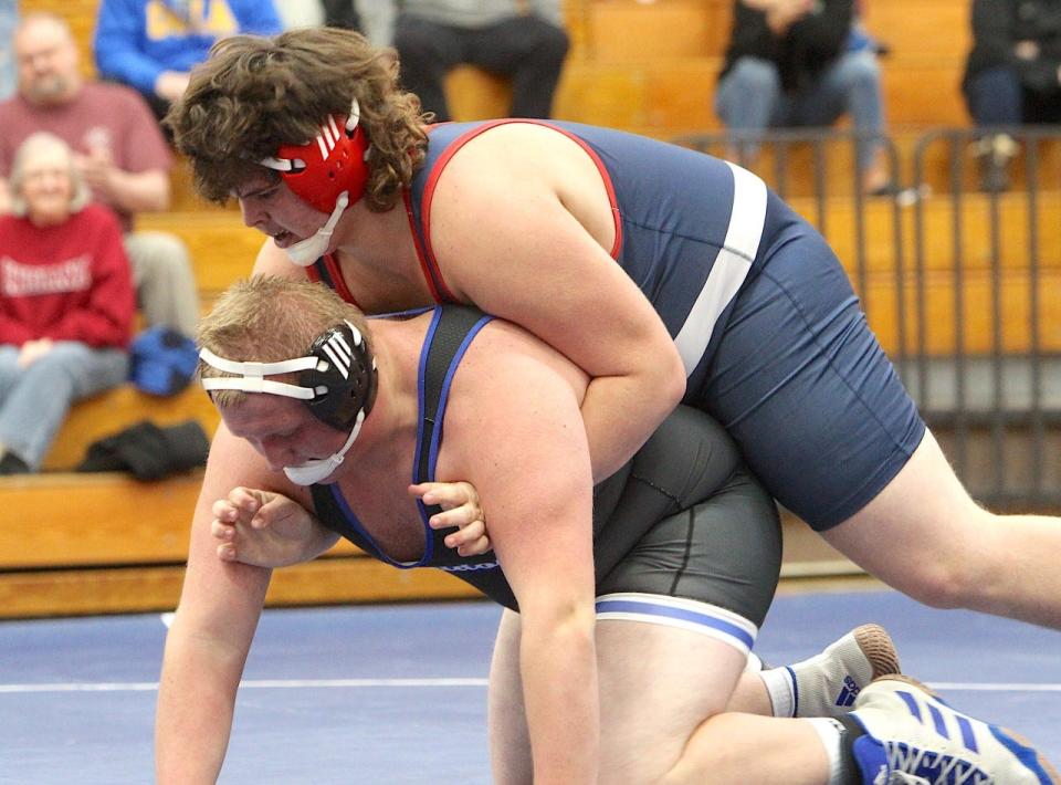 BNL freshman heavyweight Junior Arellano makes a move for a takedown and pin on Columbus North's Cody Thurnall Thursday night.