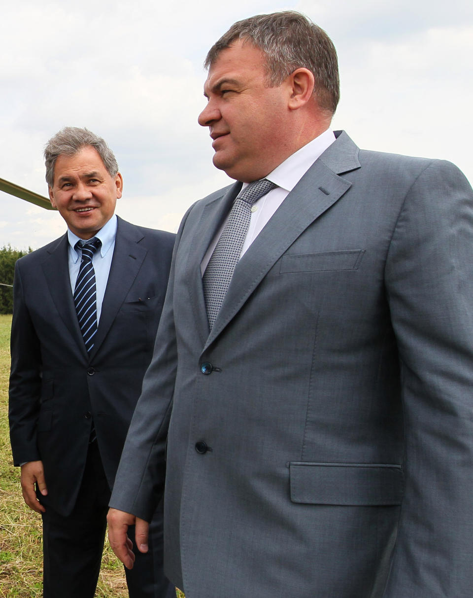 FILE - This Tuesday, June 26, 2012 file photo shows Moscow region governor Sergei Shoigu, right, and Defense Minister Anatoly Serdyukov arriving at the village of Petrovskopye, Moscow region for a meeting on the transferal of some of the military assets into civilian hands. Russian President Vladimir Putin has fired the country's defense minister two weeks after a criminal probe was opened into alleged fraud in the sell-off of military assets. Putin made the announcement of Anatoly Serdyukov's dismissal on Tuesday Nov. 6, 2012 in a meeting with Moscow regional governor Sergei Shoigu, whom he appointed as the new minister. (AP Photo/RIA Novosti, Yekaterina Shtukina, Government Press service)