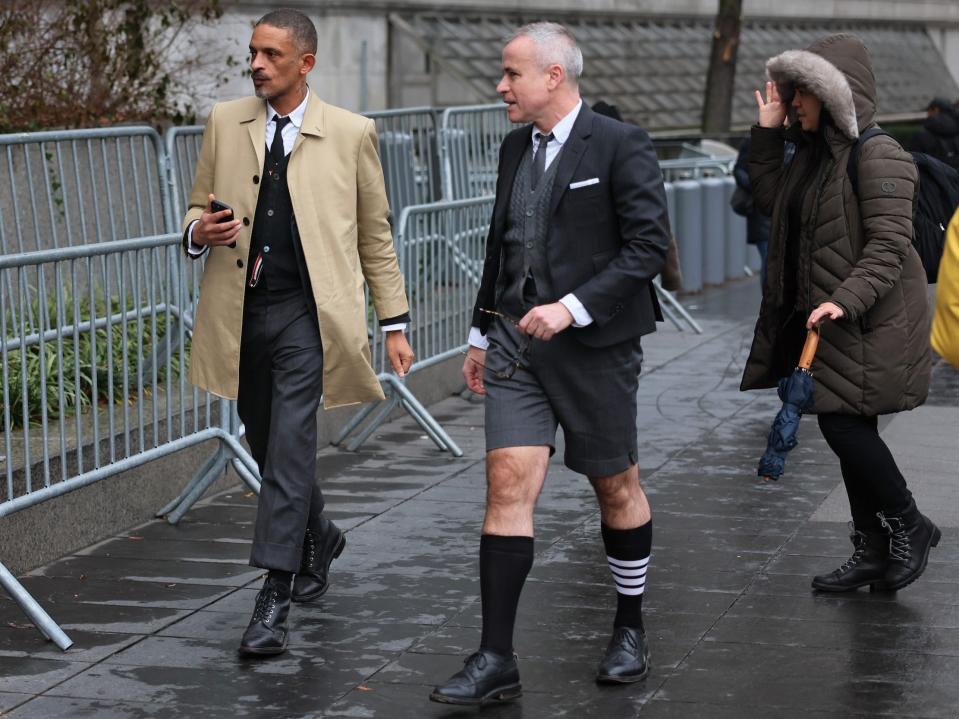 Fashion designer Thom Browne walking while wearing shorts suit and striped sock