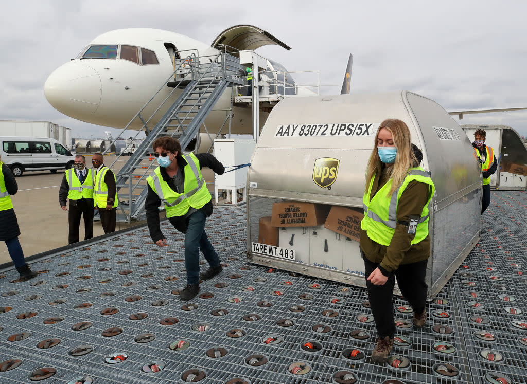 UPS employees move first shipping containers of the Pfizer-BioNTech COVID-19 vaccine in Louisville, Ky. on Dec. 13.