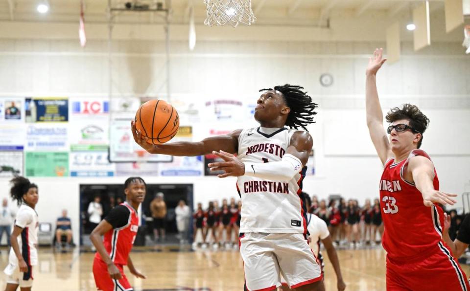 Modesto Christian’s Jeremiah Bernard scores on a reverse layup past Lincoln’s Dilan Fanucchi during the Tri-City Athletic League game at Modesto Christian High School in Salida, Calif., Friday, Jan. 12, 2024. Andy Alfaro/aalfaro@modbee.com