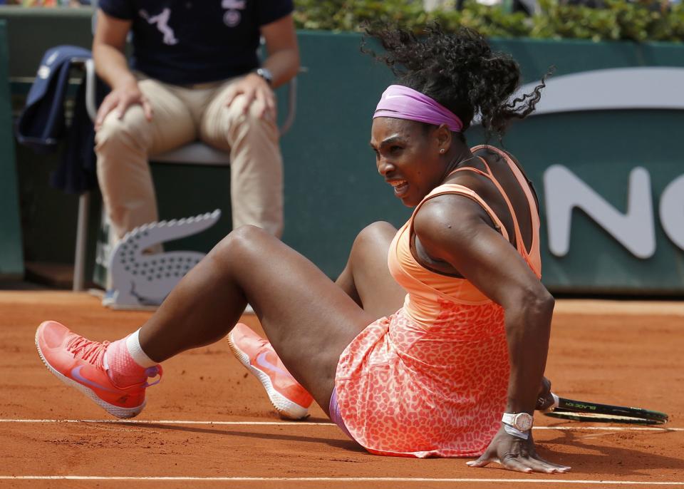 Serena Williams of the US falls during her women's quarter-final match against Sara Errani of Italy during the French Open tennis tournament at the Roland Garros stadium in Paris