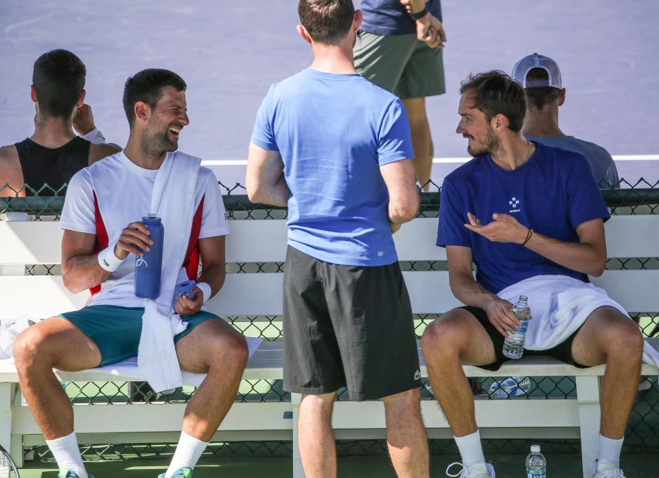 Novak Djokovic, left, and Daniil Medvedev share a laugh while taking a break during a practice session on Practice Court 2 at the BNP Paribas Open in Indian Wells, Calif., Mar. 6, 2024.