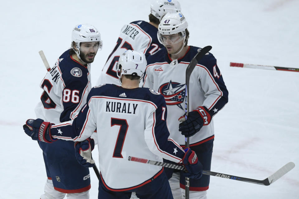 Columbus Blue Jackets' Kirill Marchenko (86) celebrates with teammates Sean Kuraly (7), Marcus Bjork (47) and Carson Meyer (72) after scoring a goal during the second period of an NHL hockey game against the Chicago Blackhawks Friday, Dec. 23, 2022, in Chicago. (AP Photo/Paul Beaty)