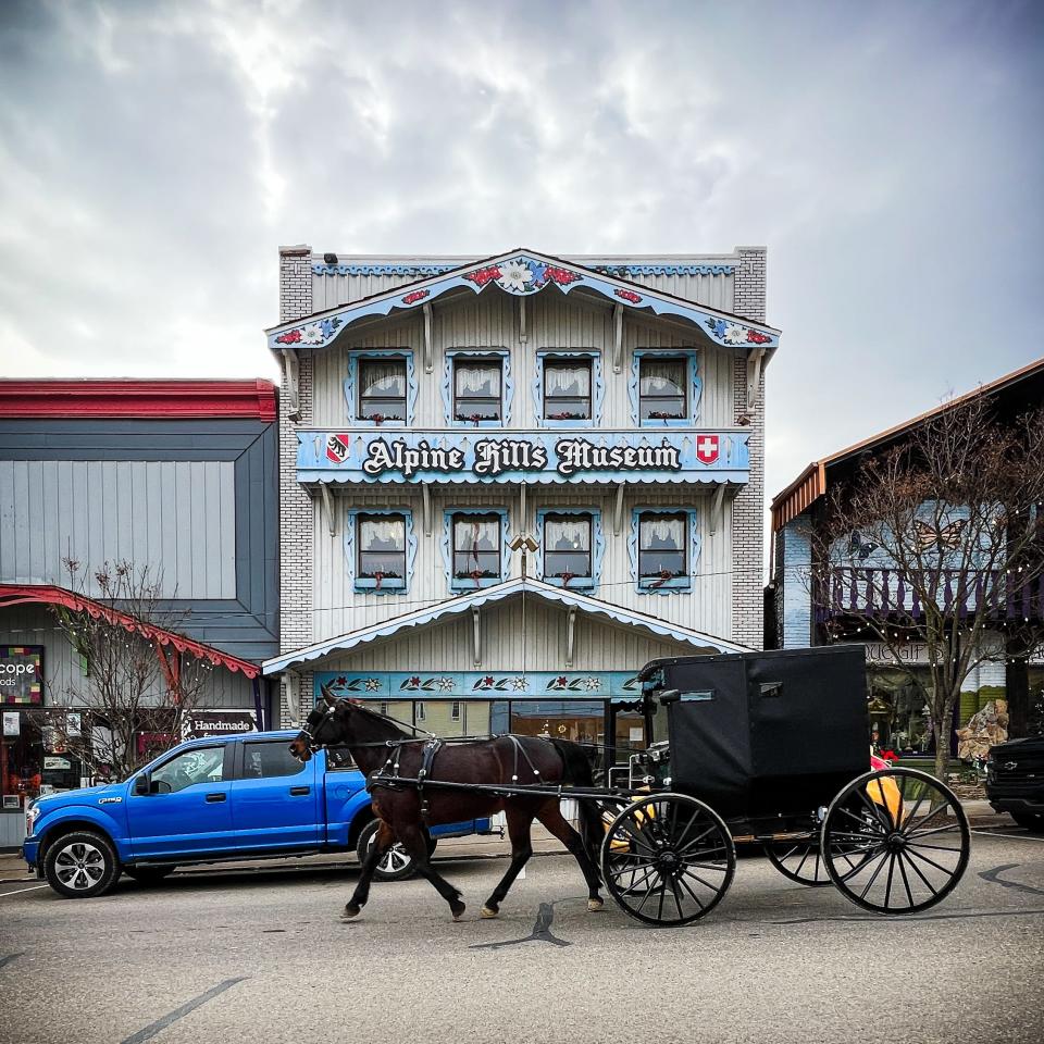 An Amish buggy passes by the Alpine Hills Museum in Sugarcreek, Dec. 22.