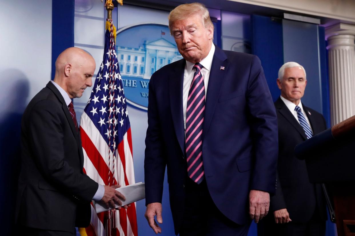 Donald Trump at a White House briefing on the coronavirus pandemic with Stephen Hahn, left, commissioner of the US Food and Drug Administration, and Vice-President Mike Pence: AP