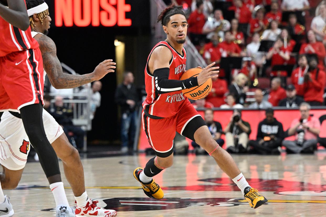 Western Kentucky Hilltoppers guard Khristian Lander (4) dribbles against the Louisville Cardinals during the first half at KFC Yum! Center, Dec. 14, 2022.