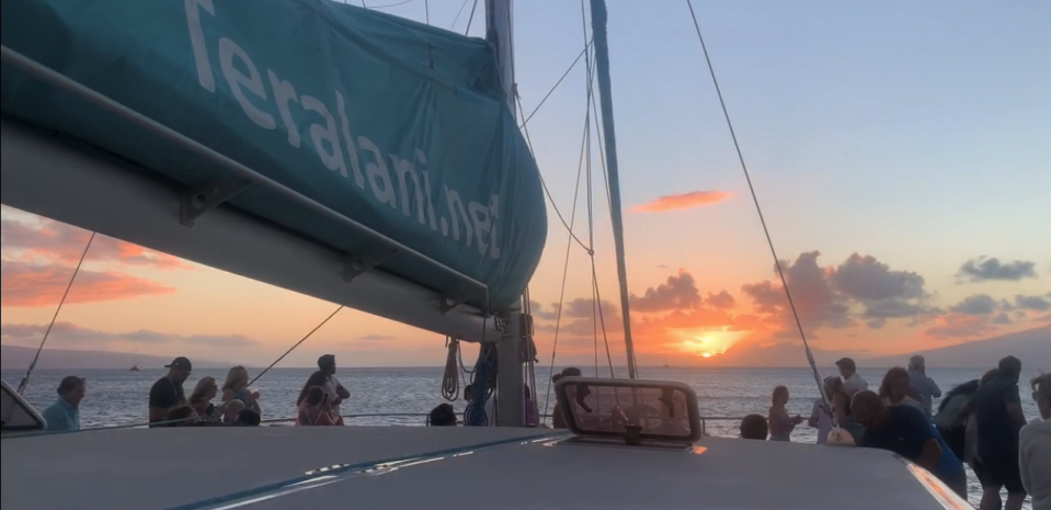 Passengers watch the sun set from a catamaran dinner cruise on the Hawaiian island of Maui on Saturday, July 3rd.