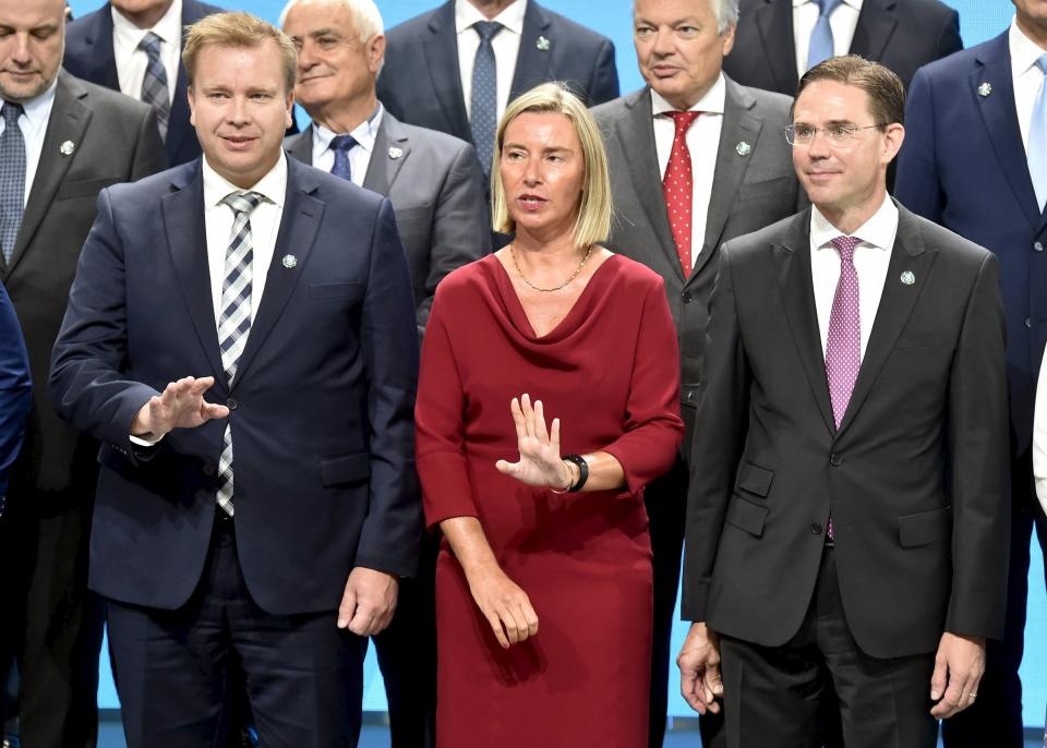 Finnish Minister of Defence Antti Kaikkonen, left, with High Representative of the European Union for Foreign Affairs and Security Policy Federica Mogherini and Finnish Commissioner of Jobs Jyrki Katainen, pose for a photo of the Informal Meeting of EU Defence Ministers in Helsinki, Finland, on Thursday, Aug. 29, 2019. The topics for discussions of the meeting include artificial intelligence and the effect of climate change on defence and security. (Jussi Nukari/