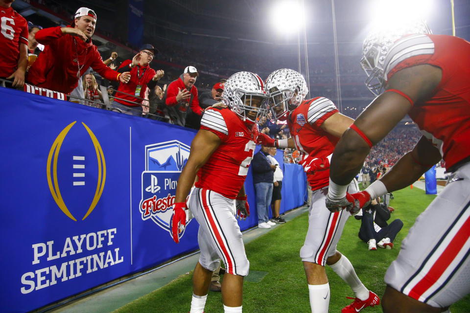 FILE - In this Dec. 28, 2019, file photo, Ohio State running back J.K. Dobbins, left, celebrates his touchdown with wide receiver Austin Mack during the first half of the team's Fiesta Bowl NCAA college football playoff semifinal against Clemson, in Glendale, Ariz. Clemson is preseason No. 1 in The Associated Press Top 25, Monday, Aug. 24, 2020, a poll featuring nine Big Ten and Pac-12 teams that gives a glimpse at what’s already been taken from an uncertain college football fall by the pandemic. Ohio State was a close No. 2. (AP Photo/Ross D. Franklin, File)