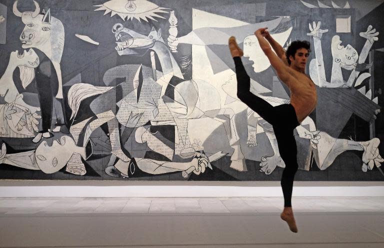 Spanish dancer Joshua Ullate performs during the general rehearsal of "Quiebro" in front of the painting "Guernica" by Pablo Picasso at the Reina Sofia Museum in Madrid on April 22, 2014
