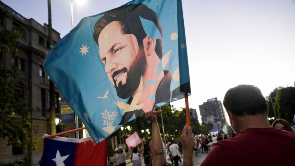 Mujer con bandera de Boric.