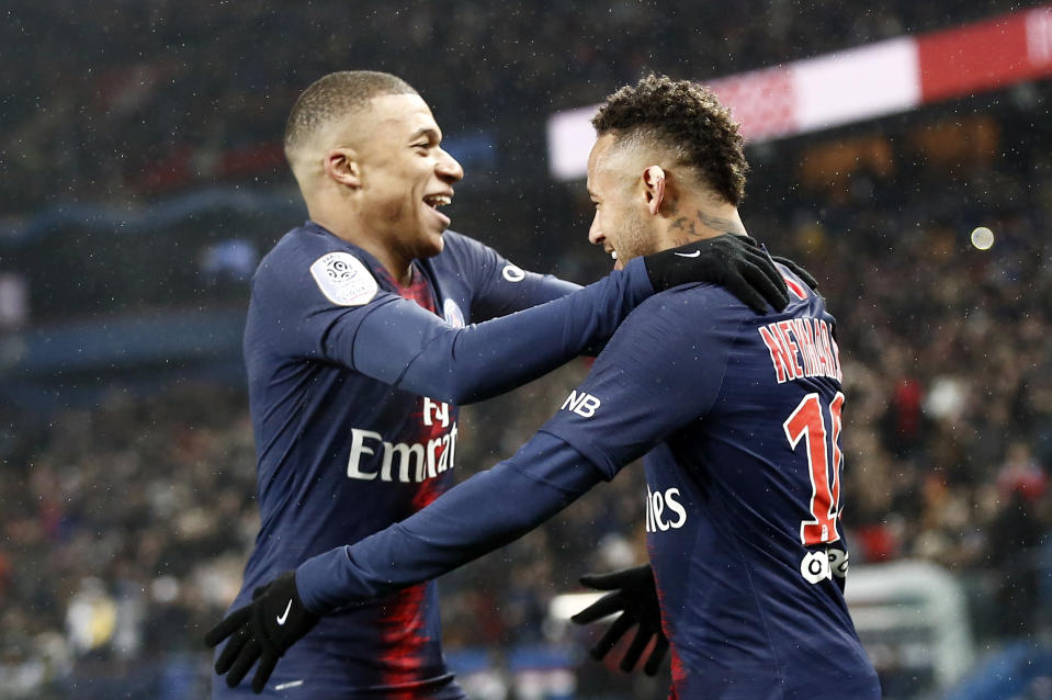 PSG's Neymar celebrates with Kylian Mbappe, left, after scoring his side's sixth goal during the League One soccer match between Paris Saint Germain and Guingamp at the Parc des Princes stadium in Paris, Saturday, Jan. 19, 2019. (AP Photo/Michel Euler)