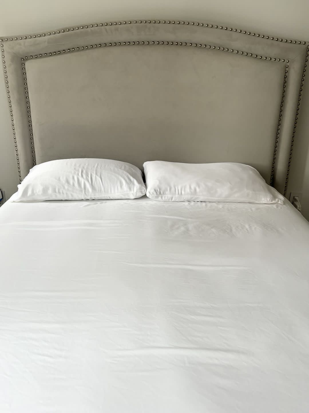 a bed with a white bed spread