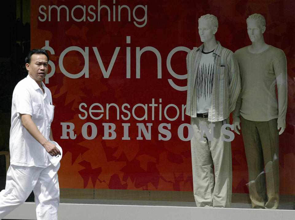 A man walks past a window display of Robinsons retail outlet in Singapore, 19 September 2003. Indonesian retailer PT Matahari Putra Prima says it is considering buying a stake in Singapore's retailer Robinson, Channel news Asia reported.  AFP PHOTO/ROSLAN RAHMAN  (Photo credit should read ROSLAN RAHMAN/AFP via Getty Images)