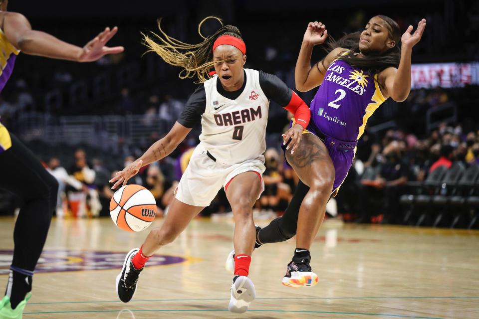 Atlanta Dream's Odyssey Sims powers past Te'a Cooper of the Los Angeles Sparks in the first half of a WNBA game at Los Angeles' Staples Center.