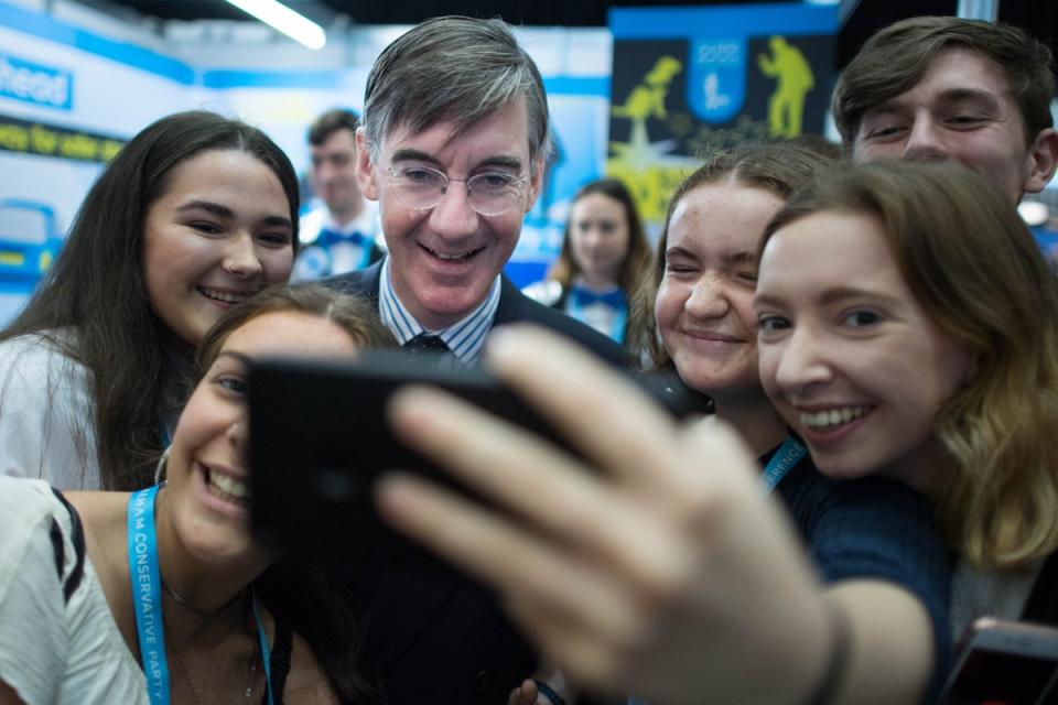 Jacob Rees-Mogg with young people during a Conservative Party Conference (Stefan Rousseau/PA) (PA Archive)