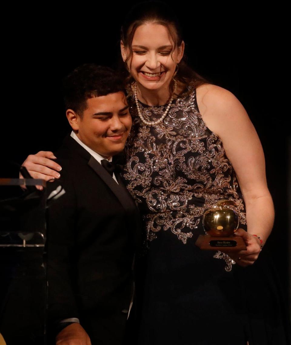 Golden apple winner Sara Kizzire is congratulated by student Julian Feliciano after receiving her award. The 2024 Golden Apple award winning teachers were honored at the Teacher Recognition Banquet on Friday, April 19, 2023, in Fort Myers. The event, sponsored by the Foundation for Lee County Public Schools, is in its 37th year of the program. 
The winners included: Sara Kizzire of Lehigh Senior High; Michelle Smith of Lehigh Senior High; Jill Klausing of Dunbar High; Christine Bartz of Pine Island Elementary; Jessica Lisi of Tanglewood Elementary; and Sarah Thornburg of Cypress Lake High.