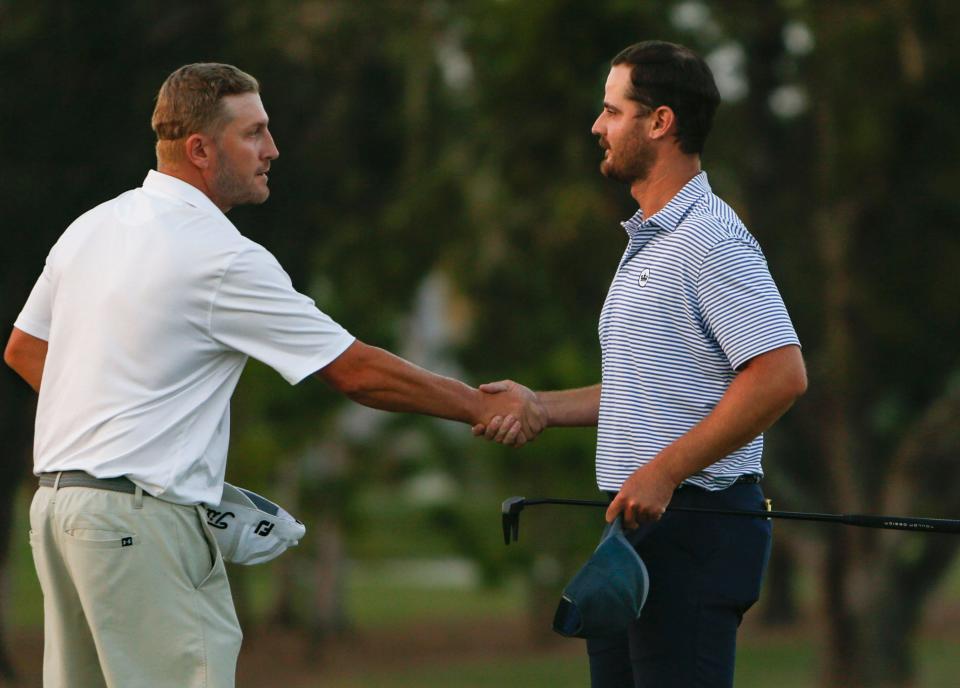 Ryan Linton congratulates Rick Lamb on the 18th hole during the final round of the 61st Yuengling Open at the Fort Myers Country Club in Fort Myers on Sunday, March 5, 2023.