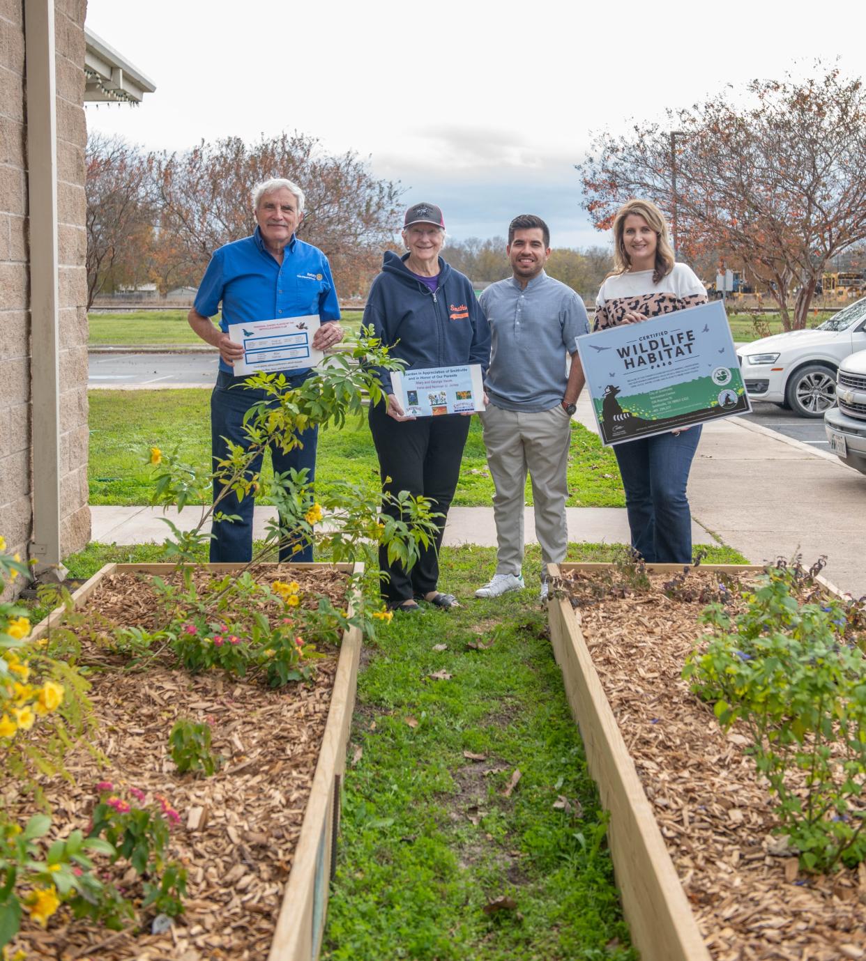 Celebrating the new raised bed garden project in Smithville are, from left, Norman Jones, president of the Lost Pines Garden Club, Janet Jones, club secretary, Jose Rivera, community engagement for the city, and Ashley Garrison, director of the Smithville Recreation Center.