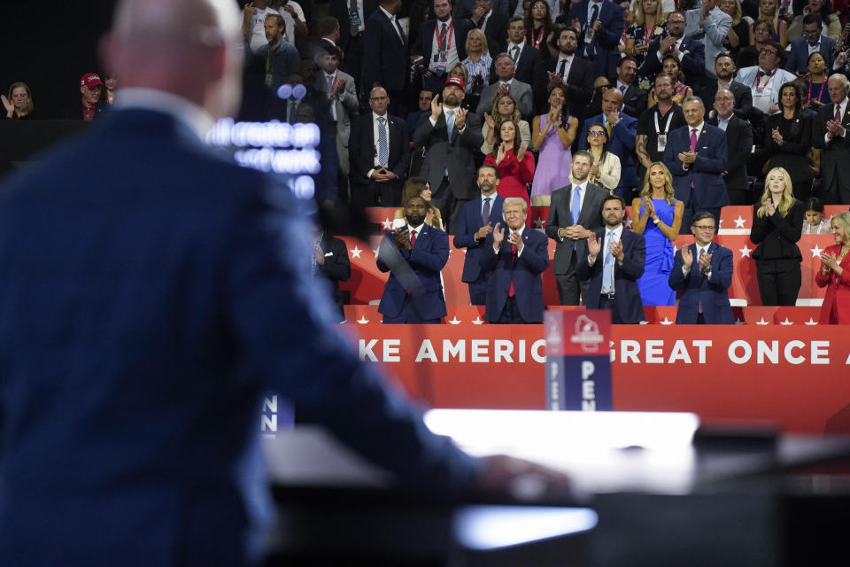 Former President Donald Trump looks on as Teamsters President Sean O'Brien speaks during the Republican convention. 