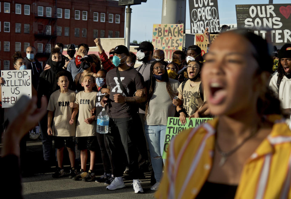 Portland Trail Blazers' Damian Lillard, center, joins other demonstrators in Portland, Ore., during a protest against police brutality and racism, sparked by the death of George Floyd, who died May 25 after being restrained by police in Minneapolis. (AP Photo/Craig Mitchelldyer)
