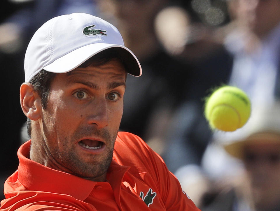 Novak Djokovic of Serbia returns the ball to Rafael Nadal of Spain during their final match at the Italian Open tennis tournament, in Rome, Sunday, May 19, 2019. (AP Photo/Gregorio Borgia)