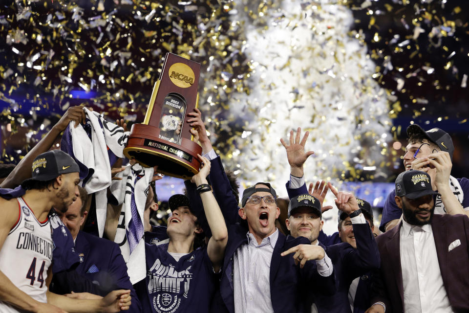 Head coach Dan Hurley of the Connecticut Huskies celebrates with his team after defeating the San Diego State Aztecs 76-59 during the NCAA Men's Basketball Tournament National Championship game at NRG Stadium on April 03, 2023 in Houston, Texas. / Credit: / Getty Images