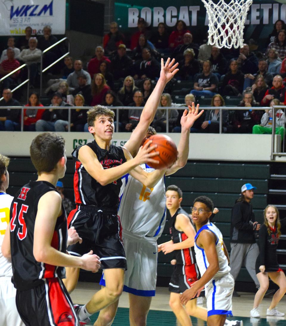 Carson Habeger drives hard past 6-7 defender Landon Vanderwarker for two of his 10 points.