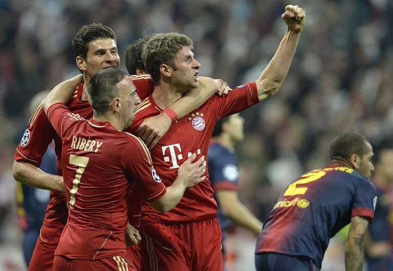 Bayern Munich's midfielder Thomas Mueller (C) celebrates scoring a goal with teammates Mario Gomez (2ndL) and Franck Ribery during their UEFA champions league semi-final first leg football match against Barcelona on April 23, 2013 in Munich, southern Germany. Bayern Munich won 4-0