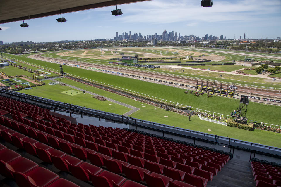 Empty stands are seen during the Finish of Race 3 prior to the Melbourne Cup horse race at Flemington Racecourse in Melbourne, Australia, Tuesday, Nov. 3, 2020. (AP Photo/Andy Brownbill)
