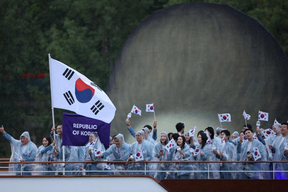 Athletes of South Korea aboard a boat in the floating parade on the river Seine during the opening ceremony (Reuters)