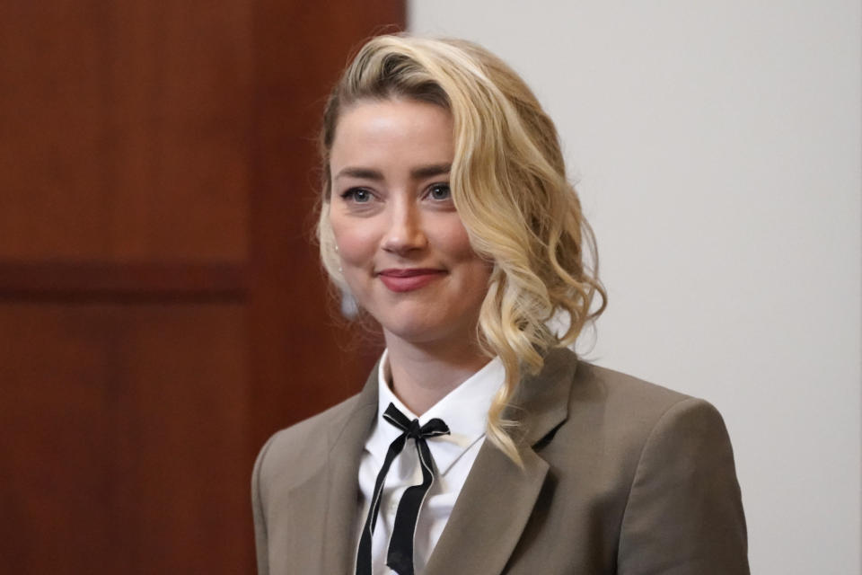 Actor Amber Heard arrives into the courtroom after a break at the Fairfax County Circuit Courthouse in Fairfax, Va., Monday, May 23, 2022. Actor Johnny Depp sued his ex-wife Amber Heard for libel in Fairfax County Circuit Court after she wrote an op-ed piece in The Washington Post in 2018 referring to herself as a "public figure representing domestic abuse." (AP Photo/Steve Helber, Pool)