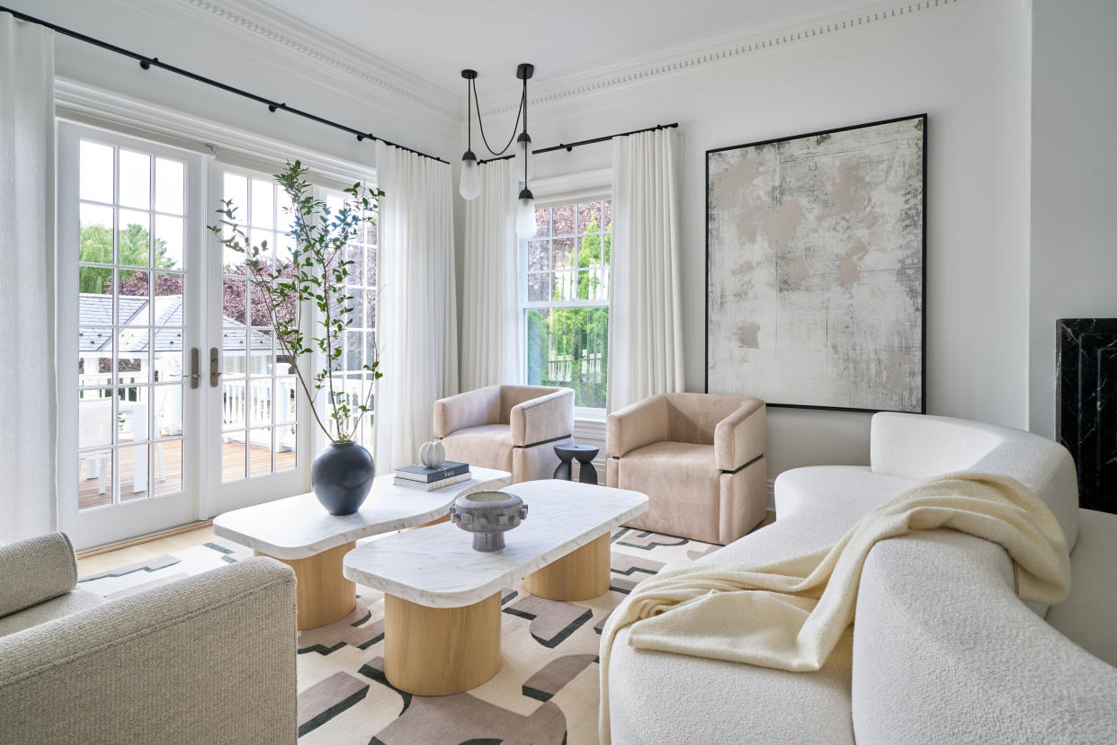  Minimalist living room with light colored furniture and artwork. 