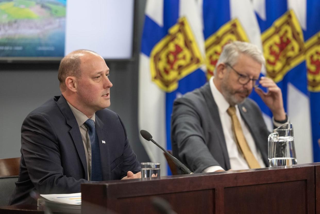 Nova Scotia Environment Minister Tim Halman (left) and Municipal Affairs Minister John Lohr take questions from reporters on Monday. (Robert Short/CBC - image credit)