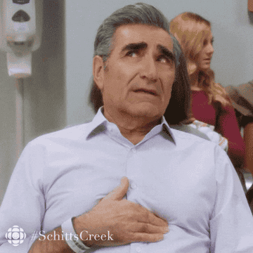 Johnny Rose from "Schitt's Creek" rubbing his chest.