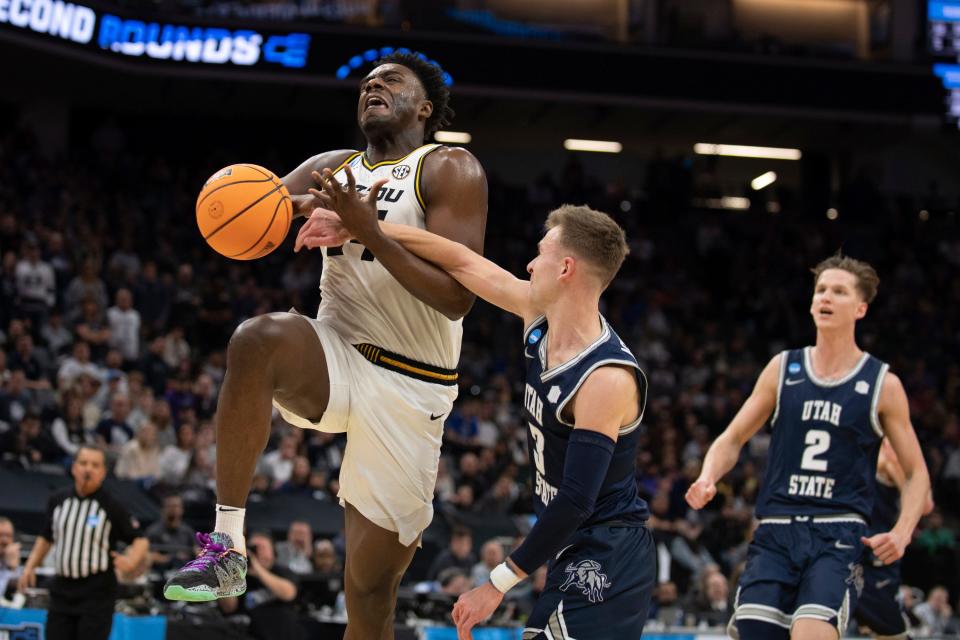 Missouri guard Kobe Brown (24) is fouled by Utah State guard Steven Ashworth (3) during the second half of a first-round college basketball game in the NCAA Tournament in Sacramento, Calif., Thursday, March 16, 2023. (AP Photo/José Luis Villegas)