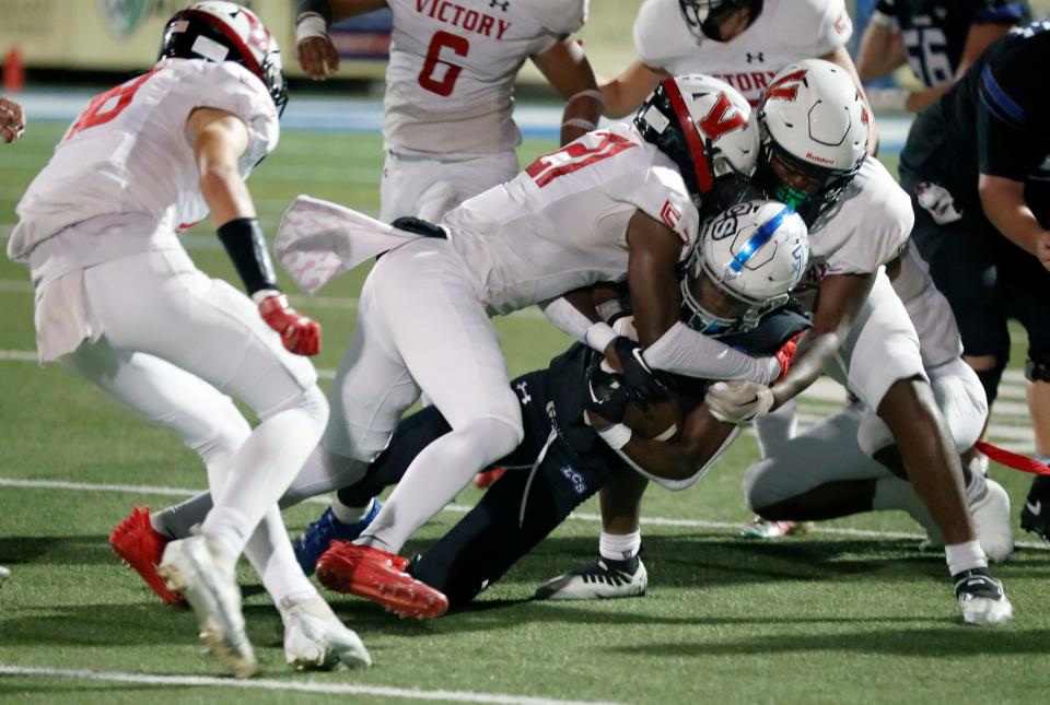 Lakeland Christian running back Josh Bellamy is tackled on a run against Victory Christian on Friday night at Viking Stadium.