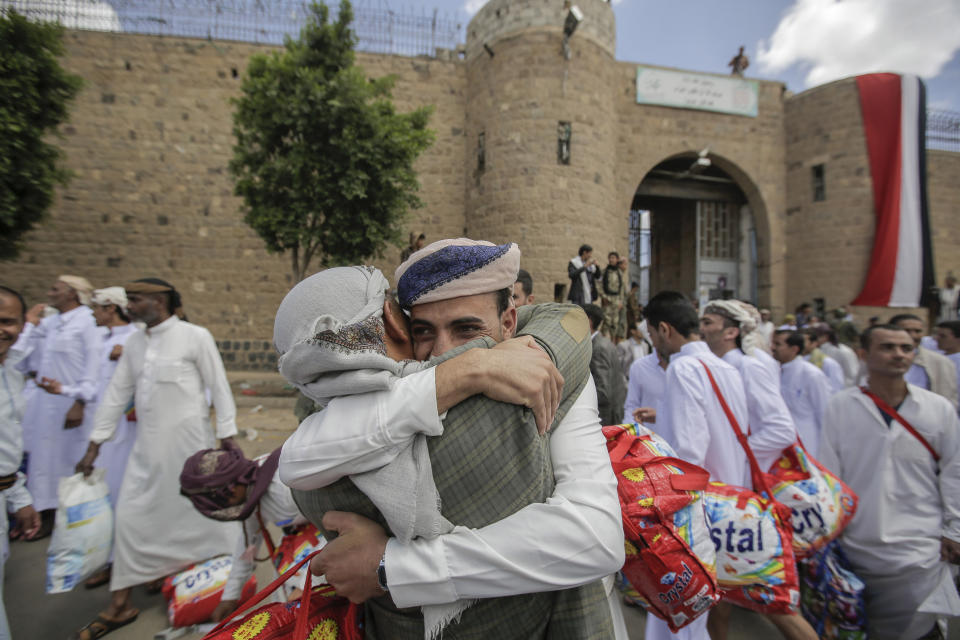 A Yemeni detainee is greeted by his relative after his release from a prison controlled by Houthi rebels, in Sanaa, Yemen, Monday, Sept. 30, 2019. The International Committee of the Red Cross said Monday that Yemen's Houthi rebels have released 290 detainees rounded up over the years and held in several detention centers across the war-torn country. (AP Photo/Hani Mohammed)