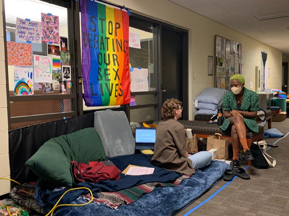 Students chat during a sit-in of the president's office at Seattle Pacific University. The sit-in is currently in its fourth week and is aimed at reversing the university's policy to not hire employees who are gay.
