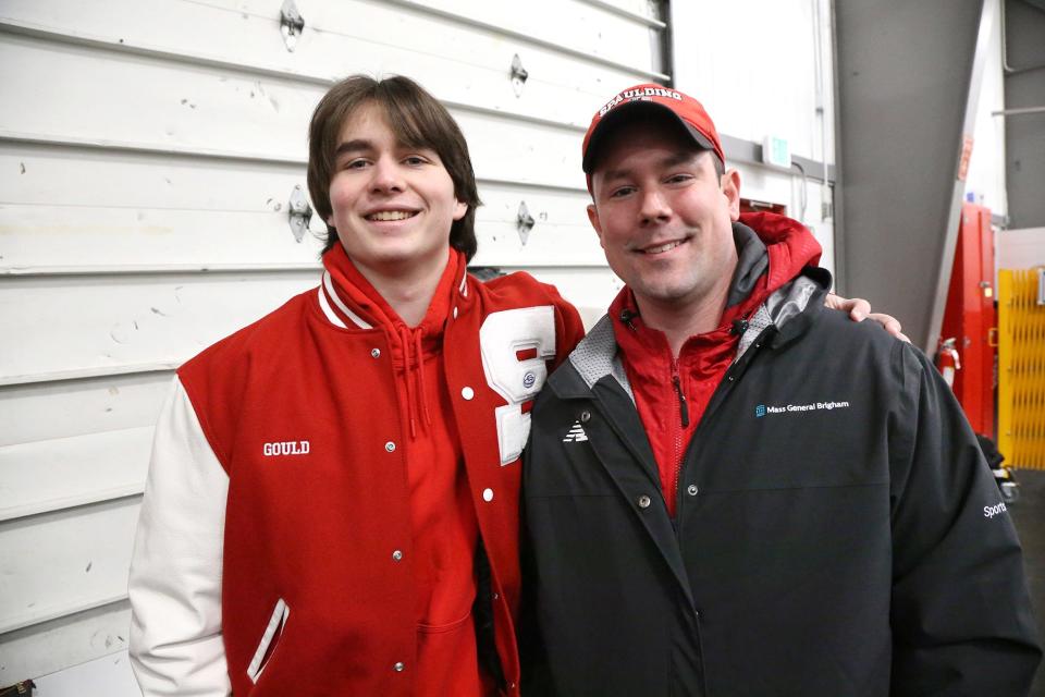 Spaulding High School junior Matt Gould puts his arm around school's athletic trainer Jon Mousette before a brief ceremony Wednesday at Rochester Ice Rink. Mousette saved Gould's life after he collapsed during a practice.