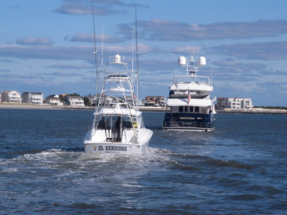 This Oct. 18, 2019 photo shows boats headed out to sea in Atlantic City, N.J. On Oct. 22, 2019, a conference at Monmouth University in West Long Branch, N.J. examined growing competition for space out on the ocean by users including the fishing, shipping, wind energy industries and conservationists. (AP Photo/Wayne Parry)