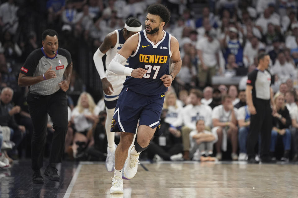 Denver Nuggets guard Jamal Murray (27) jogs down the court after making a shot during the first half of Game 4 of an NBA basketball second-round playoff series against the Minnesota Timberwolves, Sunday, May 12, 2024, in Minneapolis. (AP Photo/Abbie Parr)