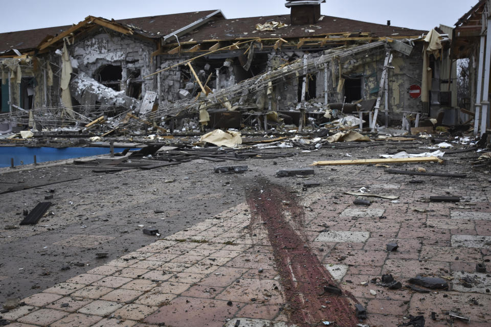 A trail of blood left by a dog killed next to a damaged restaurant after Russian shelling hit in Zaporizhzhia, Ukraine, Saturday, March 18, 2023. (AP Photo/Andriy Andriyenko)