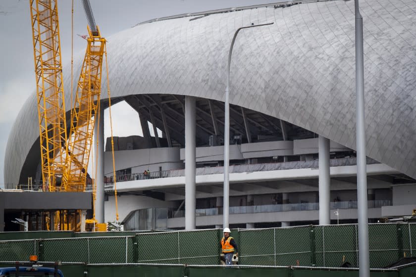 INGLEWOOD, CALIF. -- THURSDAY, MARCH 19, 2020: Construction workers work on the SoFi Stadium in Inglewood where the Rams and Chargers will be playing Thursday, March 19, 2020. (Allen J. Schaben / Los Angeles Times)